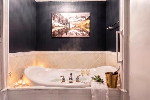 a bathroom with a bath tub and a sink at Launchpoint Lodge in Lincoln