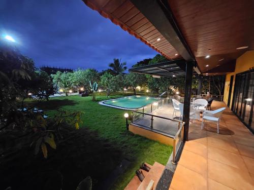a backyard with a swimming pool at night at Rajashree Multipurpose Resort in Solapur