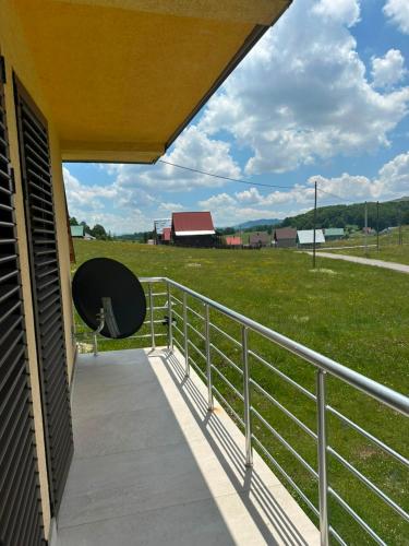 a balcony with a fence and a field of grass at Family house, Savin kuk in Žabljak