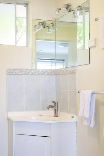 a bathroom with a sink and a mirror at Robe Sunset Apartments in Robe