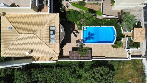 an overhead view of a house with a swimming pool at Villa Kyma in Platána