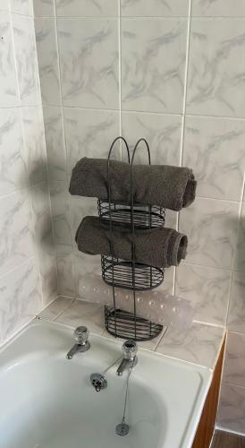 a bathroom sink with a towel rack above it at Charming Kintbury Cottage in Kintbury