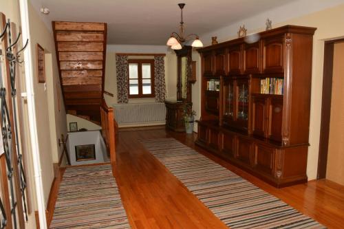 a living room with wooden floors and a staircase at Klein Schöntal in Göstling an der Ybbs