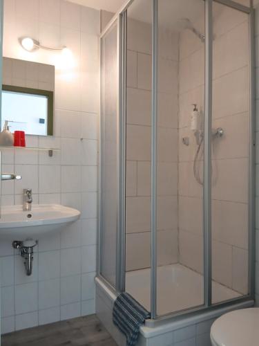 a bathroom with a shower and a sink at Pension Küfner in Markkleeberg