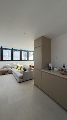 a living room with a couch and a kitchen at Avanel Private Pool Penthouse in Ronda
