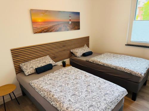 two twin beds in a room with a lighthouse at Idar Apartment 2 in Idar-Oberstein