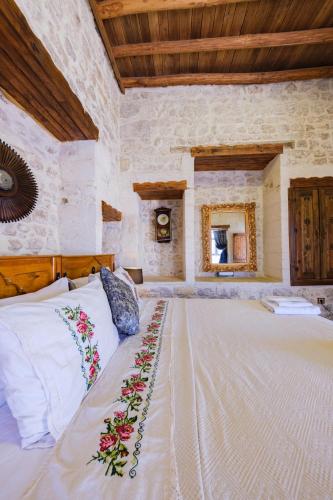 a bedroom with a large bed in a stone wall at BABIL ANTIQUE HOTEL in Urfa