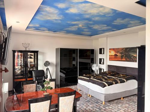 a bedroom with a bed and a dining room at Sleep Inn Hotel in Paderborn