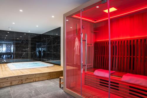 a red bathroom with a shower and a tub at Izoard in Saint-Chaffrey