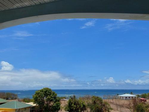 a view of the ocean from a balcony of a house at Le Paradis des Anges - Retraite spirituelle & Douceurs des Caraïbes in Le Vauclin