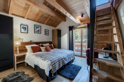 a bedroom with a bed and a staircase in it at Galibier in Saint-Chaffrey