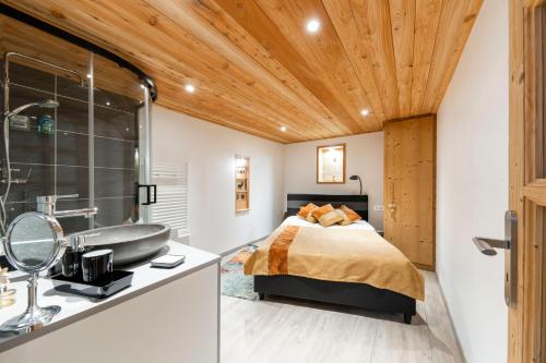 a bedroom with a bed and a sink and a tub at Echyllo in Forville