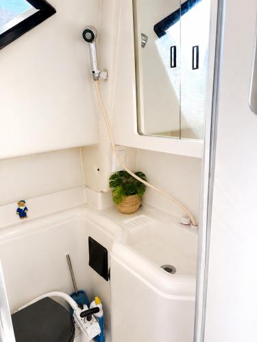 a small bathroom with a sink and a mirror at bahati blue riviera in Mandelieu-La Napoule