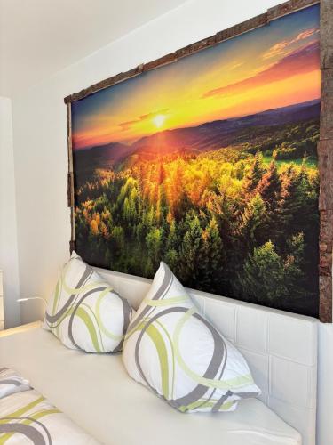 a painting of a forest with the setting sun at Appartement Landzeit im Waldviertel in Steinbach