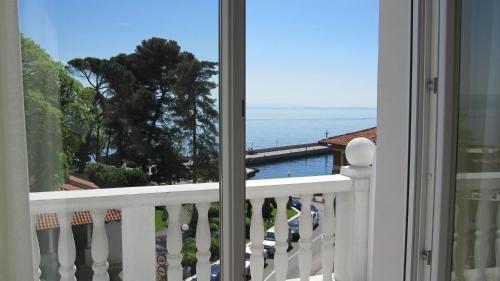 a balcony with a view of the ocean at Hotel Park in Lovran