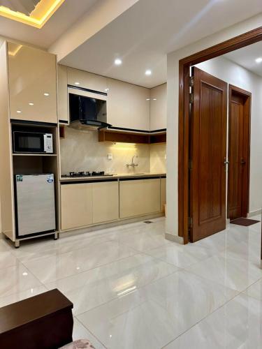 a large kitchen with a stove and a refrigerator at Premium Pavilion in Islamabad