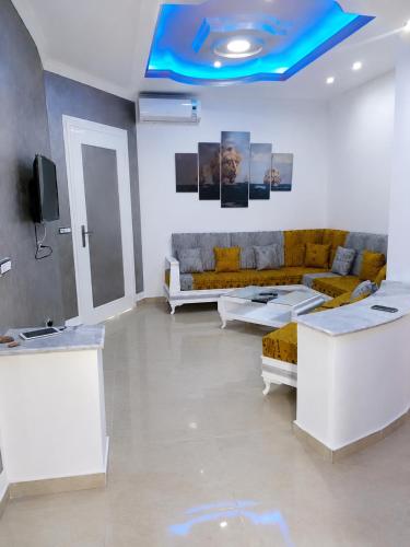 a living room with couches and a blue ceiling at ben mesaaoud in Kelibia