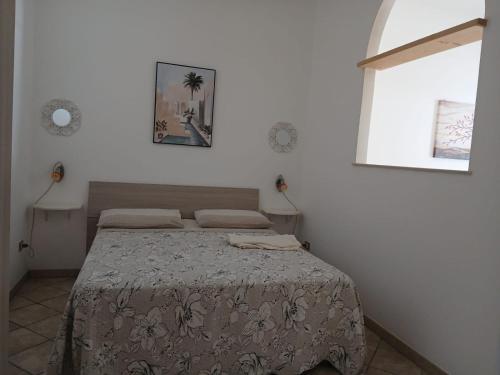 a bedroom with a bed in a white room at il Pascià Affittacamere in Otranto