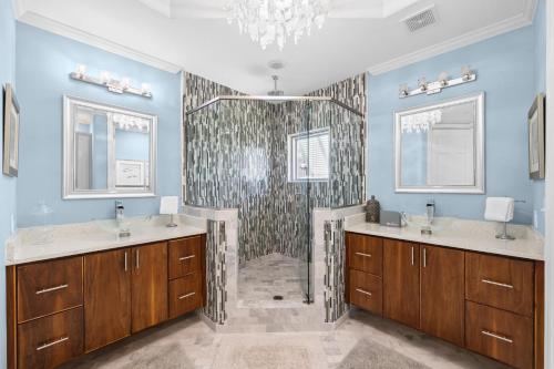 a bathroom with two sinks and a shower at The Alexander in Rosemary Beach