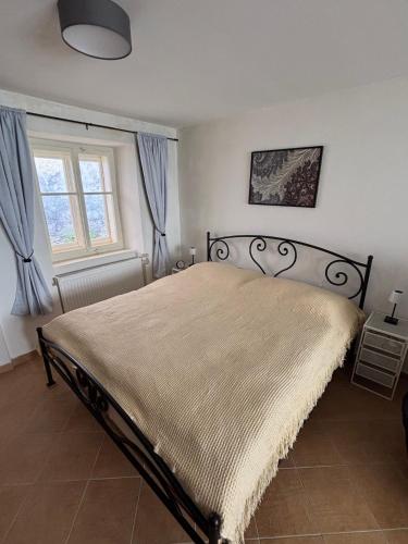 a bedroom with a large bed with a blanket at BrezINNa - 200 let historie - moderní chalupa in Počátky