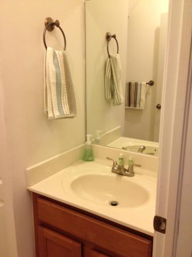 a bathroom with a sink and a mirror at Speedway Blvd Townhouse in Homestead