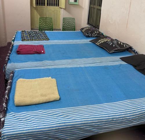 a group of three blue beds in a room at CHIDAMBARAM Bala Residency in Chidambaram