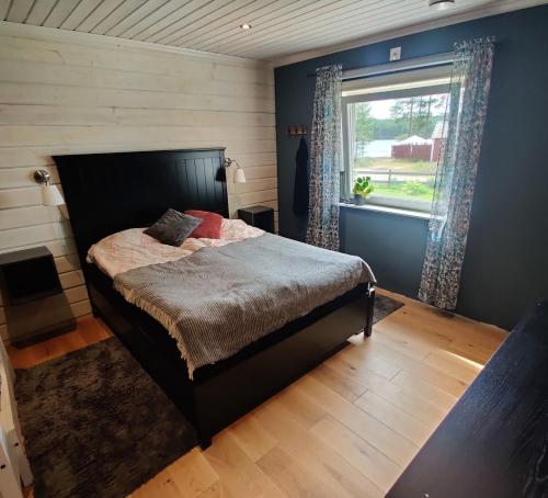 a bedroom with a large bed with a window at Ulriksdal in Ulriksdal