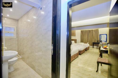 a bathroom with a bed and a toilet and a sink at Comfort Pyramids Inn in Cairo