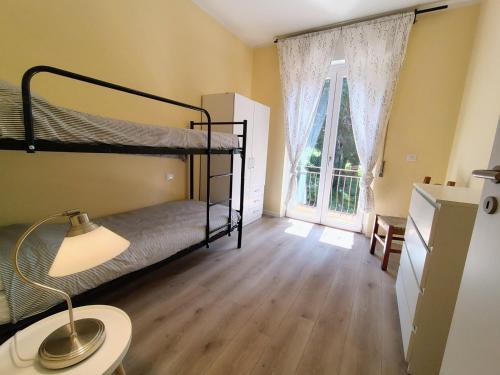 a bedroom with two bunk beds and a window at casa marina in Pettenasco