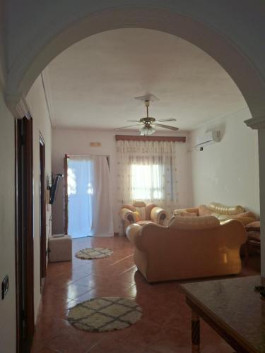 a living room with couches and a ceiling fan at Hills Villa in Vlorë
