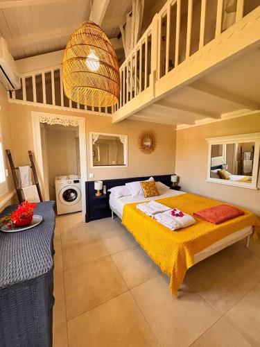 a bedroom with a large bed and a staircase at Orient Bay charming in Saint Martin