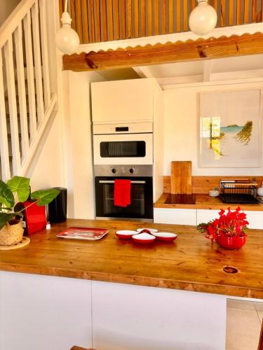 a kitchen with a counter with a stove top oven at Orient Bay charming in Saint Martin