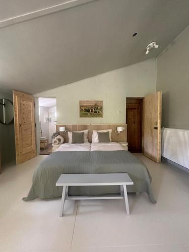 a large bedroom with a large bed and a table at Zen appartement in Vries