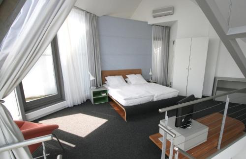 a hotel room with a bed and a television at Chelsea Hotel in Cologne