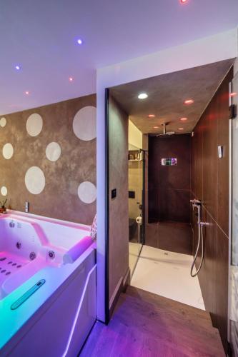 a bathroom with a pink tub and a shower at Suite Apartment Taormina in Taormina