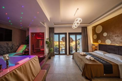a hotel room with a large bed and a tub at Suite Apartment Taormina in Taormina
