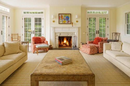 a living room with couches and a fireplace at The Whistling Oak - Pristine Pond Tranquility in Craryville