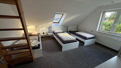 a small room with two beds and a window at Private Home in Hamburg in Hamburg