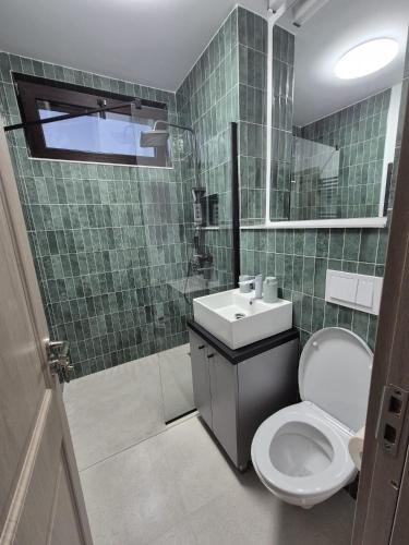 a bathroom with a toilet and a sink at The Garden Apartment in Bîrlad