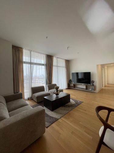 a living room with a couch and a tv at Luxury Apt l La Gare in Addis Ababa