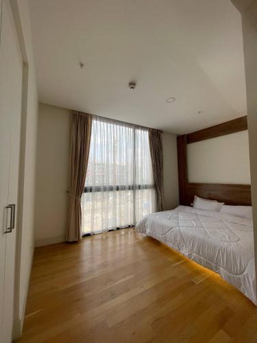 a bedroom with a bed and a large window at Luxury Apt l La Gare in Addis Ababa