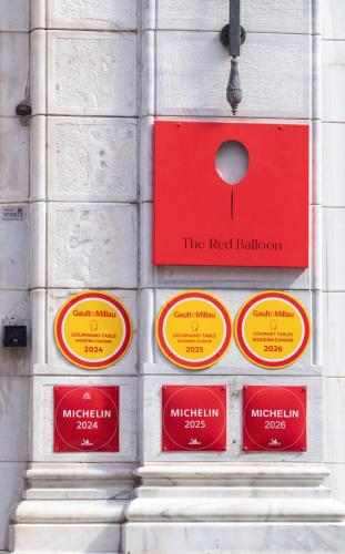 a wall with red and yellow signs on it at Mr Cas Hotels Taksim - Special Category in Istanbul