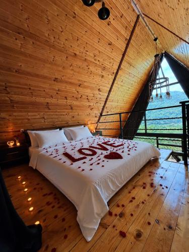 a bed in a room with a wooden ceiling at Panorama Cottage in Erge