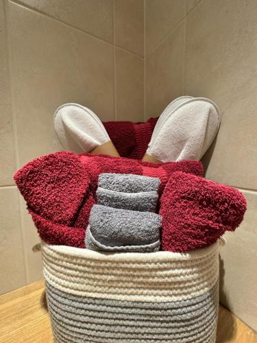 a basket filled with towels and a pile of socks at Trumpan Cottage Bed & Breakfast in Trumpan