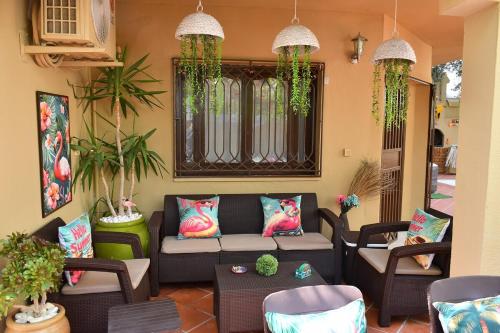 a living room with a couch and chairs at Hacienda Oliva in Hammam Sousse