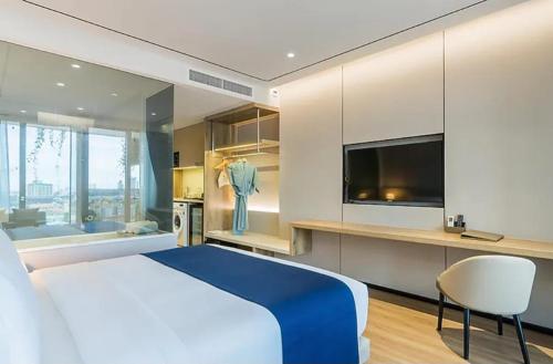 a bedroom with a large bed and a television at The- Luxury Enclave Plaza Near IGI Airport Delhi in New Delhi