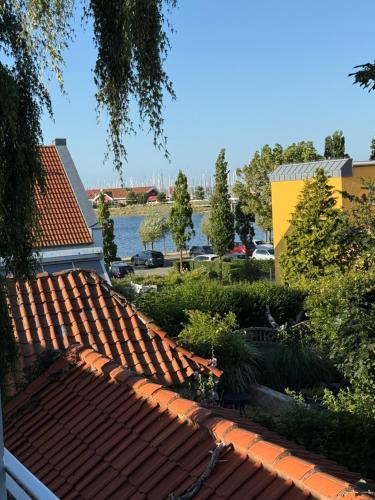 a view of the roofs of a building with a lake at Gästehaus am Binnensee in Heiligenhafen