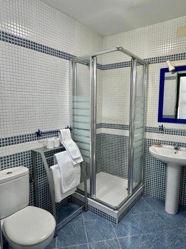 a bathroom with a shower and a toilet and a sink at Apartaments Tramuntana in Port de la Selva