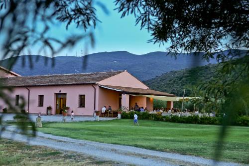 ein Gebäude mit einer Gruppe von Leuten im Hof in der Unterkunft Agriturismo Ristorante Monte Argentario in Monte Argentario