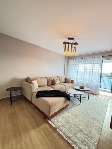 a living room with a couch and a chandelier at Kasarani trm in Nairobi